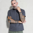 Premium Fitted Heritage Tee in Washed Black, front view on model, arms crossed