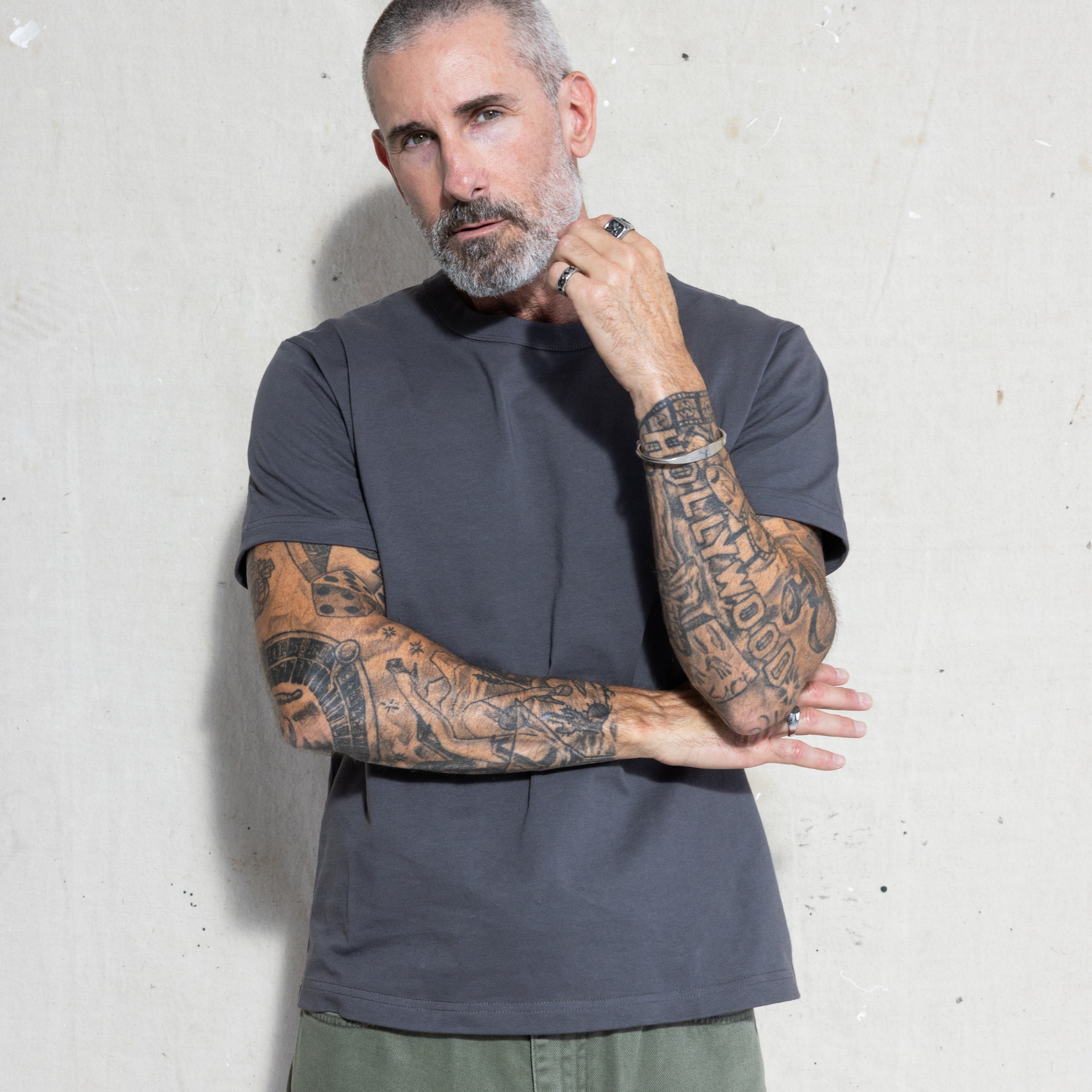 Premium Fitted Heritage Tee in Washed Black, front view on model, arms crossed
