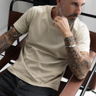 Premium Fitted Heritage Tee in Heritage Sand, seated on model